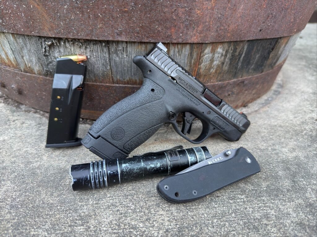 Gear for new gun owners: A knife, Smith & Wesson Bodyguard 2.0, flashlight, and knife.