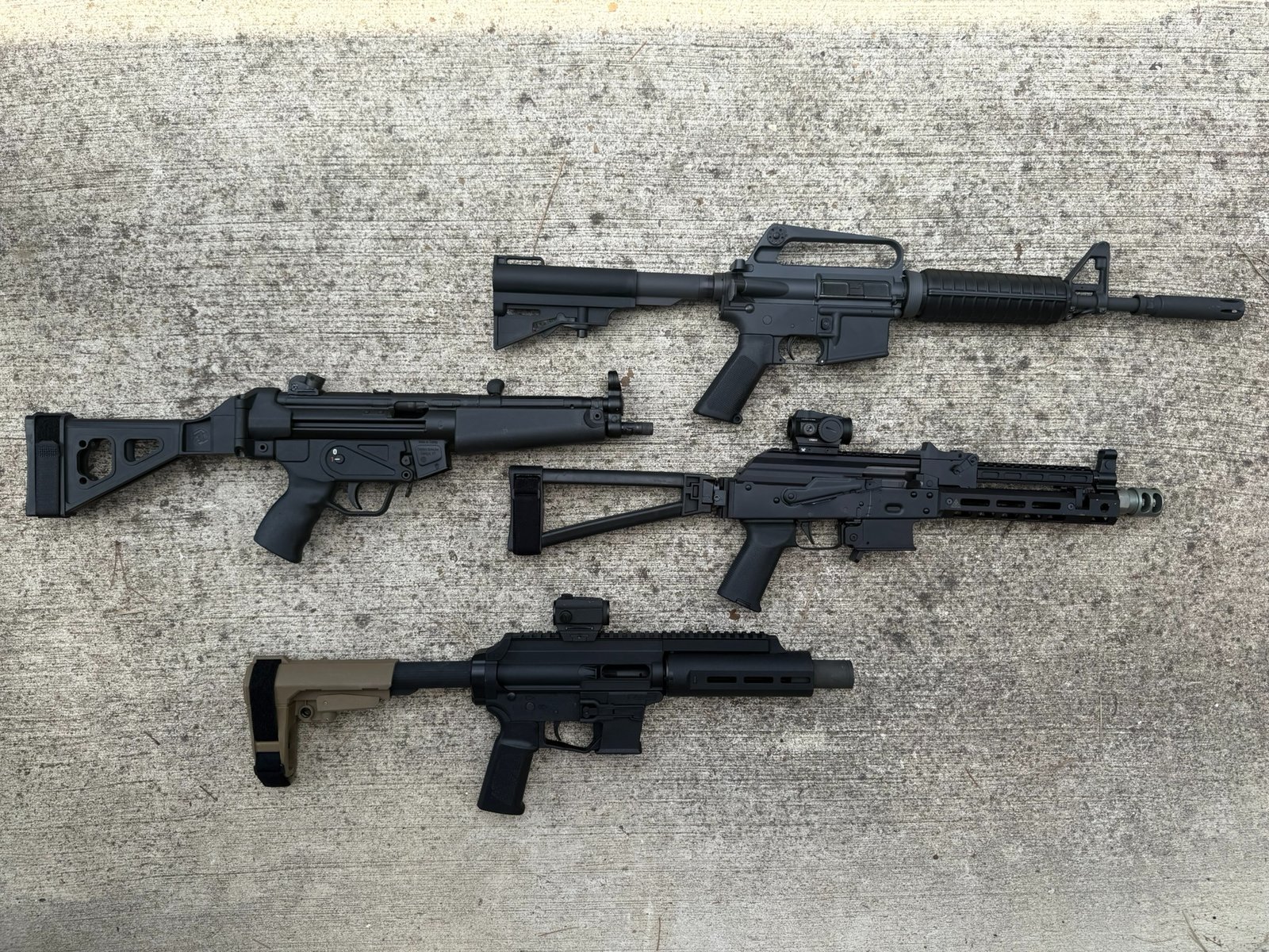Four different styles of large frame pistols with a pistol brace.