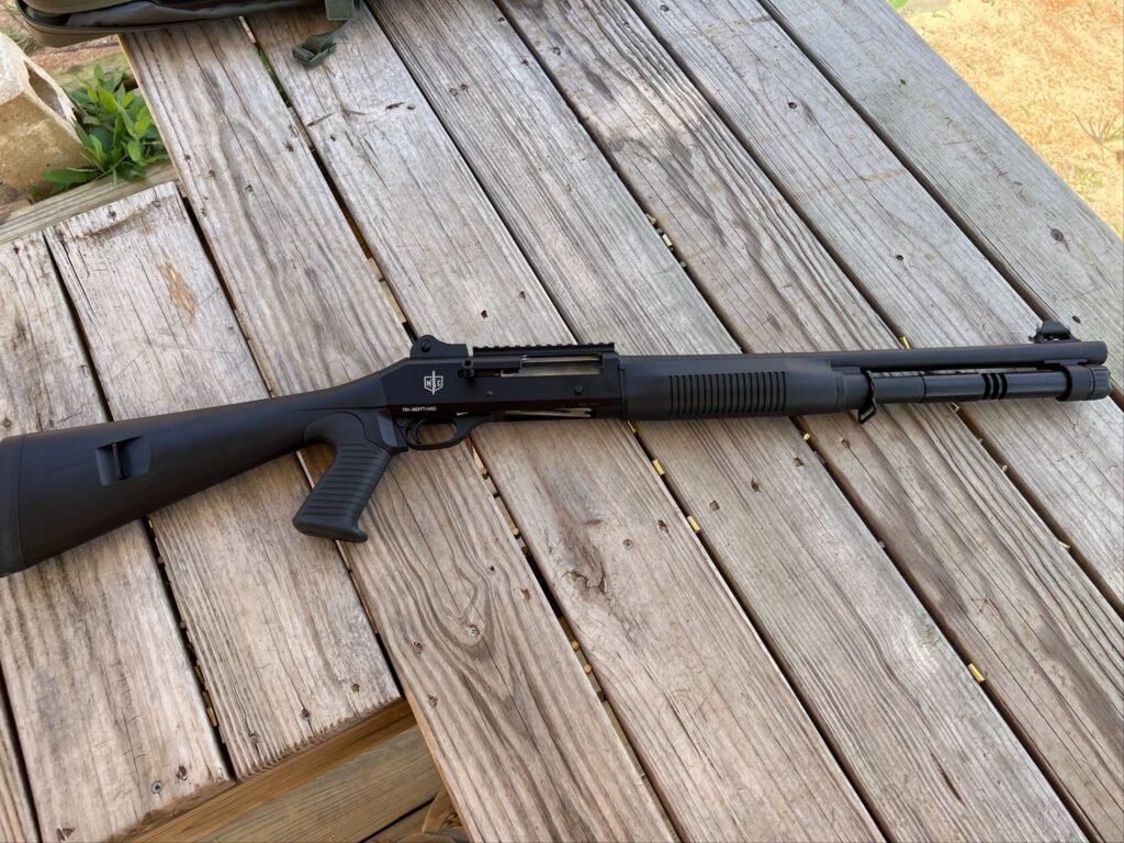 Semi-automatic shotgun laid out on a wooden bench, illustrating a common home defense firearm platform discussed in the context of shotgun ammunition selection and overall home defense ammunition considerations.