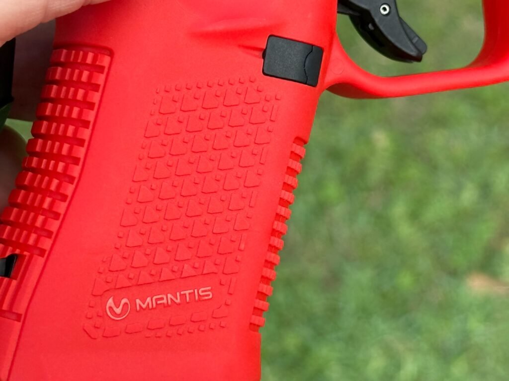 Close-up of Mantis TitanX laser training pistol grip texture and frame detail for dry fire training use