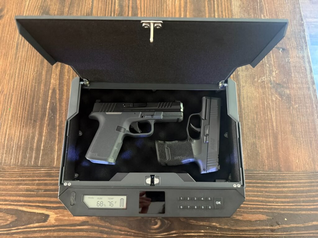 XEGIS Safe Palm Vein Biometric Gun Safe open with Glock 17 and Sig P365 inside, showing interior lighting, keypad, and quick-access handgun storage design.