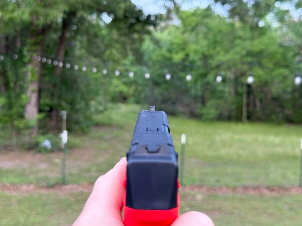 Sight picture from Mantis TitanX laser training pistol aimed downrange during dry fire training practice