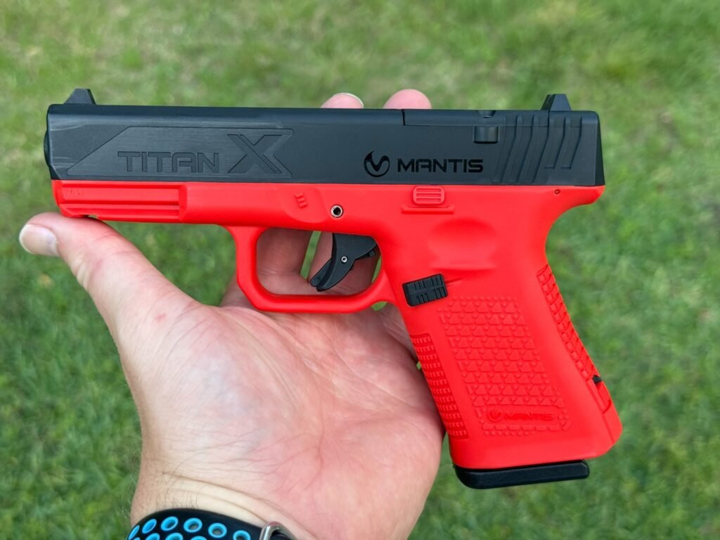 Mantis TitanX laser training pistol full side profile showing red frame and black slide for dry fire training