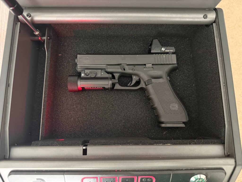 Hornady Rapid Safe Keypad Vault interior holding Glock 17 with weapon light and red dot optic