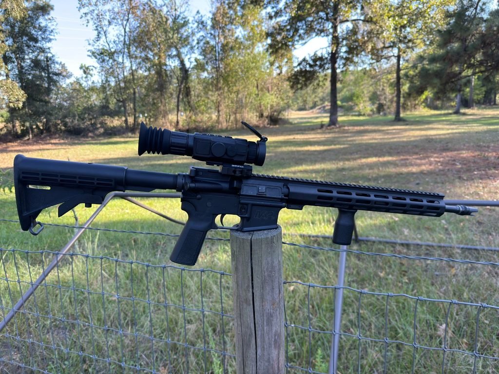 DNT Hydra HS635R thermal scope mounted on an AR-15 rifle outdoors